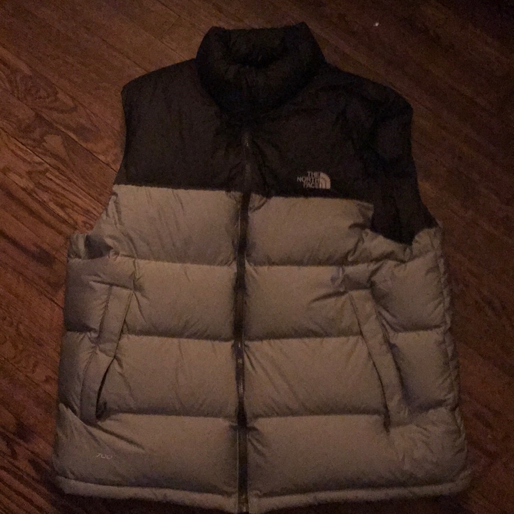 Grey and black puffy north face vest